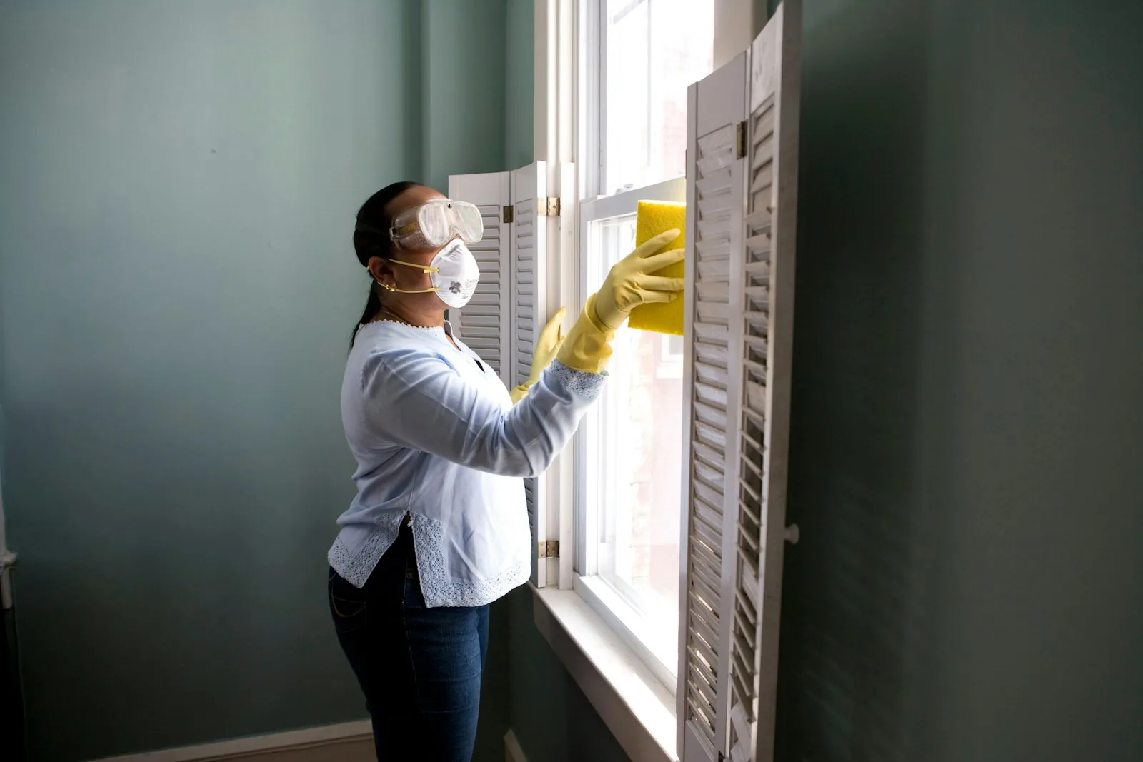 Cleaner wiping a residential window
