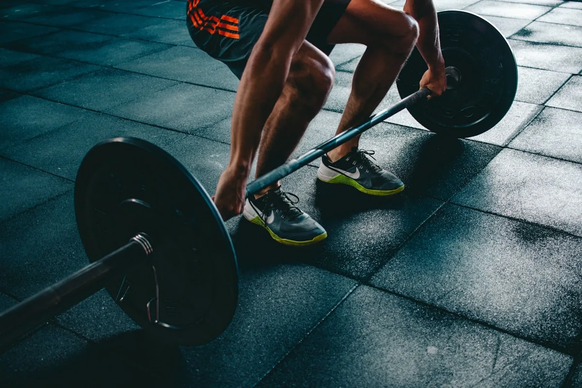 Athlete training with a loaded barbell in a gym