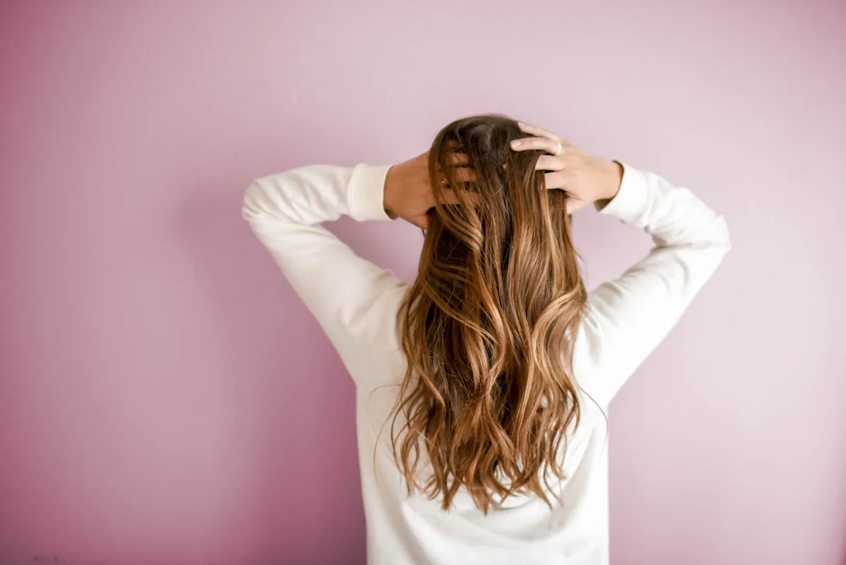 Stylist blow-drying a client's hair in the salon
